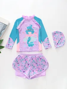 Three-piece girls mermaid swimsuit set with long sleeves, ruffle details and ocean print