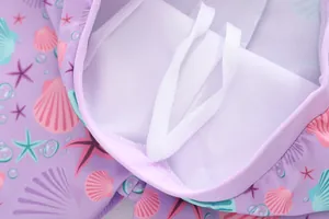 Detail of girls mermaid swimsuit featuring ocean print fabric and soft mesh lining