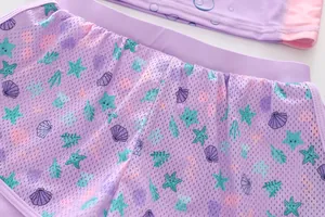 Detail of purple breathable mesh shorts with ocean shell prints and elastic waistband