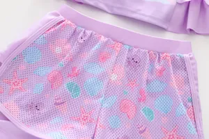 Close-up of girls mermaid swim shorts in lavender with marine life pattern and mesh fabric