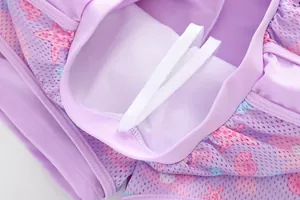 Detailed macro view of mermaid style kids swimwear with starfish print and mesh lining
