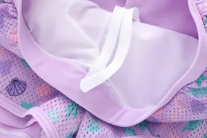 Detailed view of light purple mermaid print swim shorts with mesh lining and white drawstring