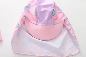 Detailed view of pink mermaid style sun protection swim hat with neck flap for girls