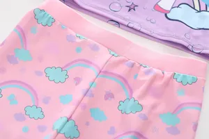 Detailed view of kids mermaid swimsuit showing pink printed pants and purple seam stitching
