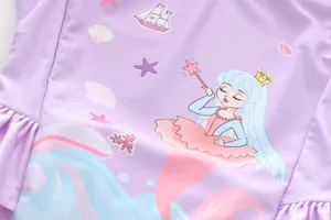 Detail of purple mermaid swimsuit featuring cartoon princess print and ocean patterns