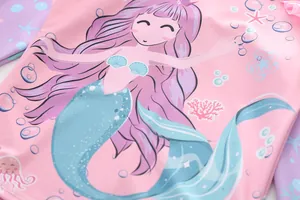 Detailed close-up of a pink mermaid print on kids' ruffle swimwear with sea life patterns