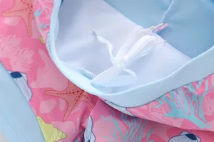 Dettaglio del costume a sirena rosa con stampe di stelle marine, coulisse bianca e fodera