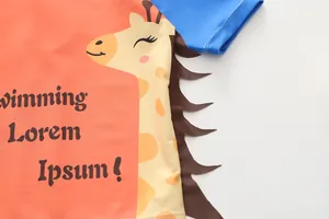 Dettaglio del costume da bagno arancione per bambini con stampa a giraffa e maniche blu