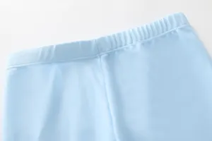 Detail of light blue boys' swimwear featuring elastic waistband and reinforced stitching