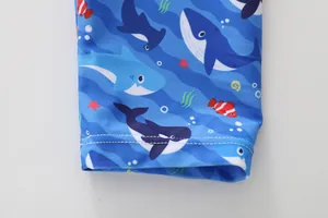 Detail of blue boys' swimwear featuring ocean shark print and durable flatlock stitching