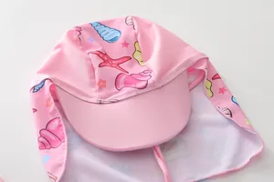 Pink kids swim cap with neck flap featuring starfish and seashell marine prints