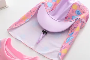 Close-up of kids pink swimming cap with sun protection neck flap and ocean pattern