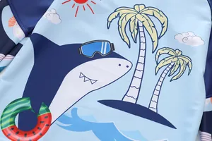 Detail of children's long-sleeve swimwear featuring a cute cartoon shark and beach print
