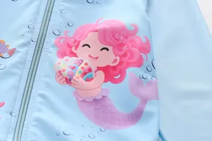 Detail of mermaid print and zipper on light blue long sleeve girls' swimsuit jacket