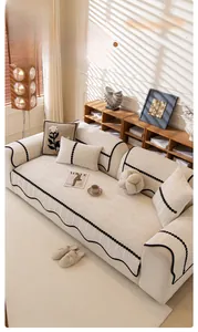 Detailed view of 3D texture chenille sofa cover with black polka dot ribbon trim