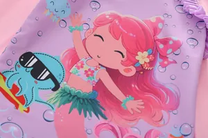 Detail of mermaid illustration and purple ruffled hem on kids' two-piece swimsuit