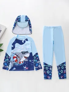 Detailed view of kids long-sleeve shark rash guard, matching pants and swim hat