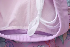 Detail of girls swimwear showing shell print fabric, white mesh lining and drawstrings