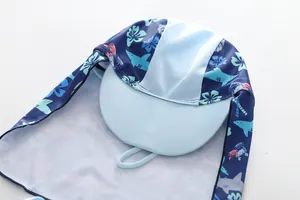 Detail of kids sun protection swim hat with neck flap and cartoon shark patterns