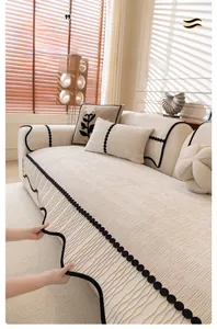 Detail of chenille sofa cover showing 3D texture and black wavy polka dot edge trim