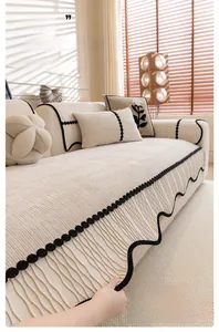 Detail of cream chenille sofa cover showing 3D floral texture and black wavy trim