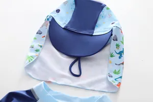 Detail of sun-protective kids swimming cap with cartoon dinosaur prints and neck flap