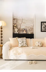 Detail of plush cream rose embossed sofa cover with elegant scalloped wavy edges