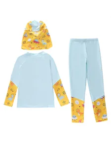 Detailed view of kids' long-sleeve sun protection swimsuit with cartoon dinosaur print