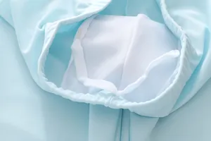 Detail of light blue boys swimwear showing breathable mesh lining and drawstring waist