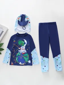 Flat lay of boys' navy blue space-themed swimwear with dinosaur and rocket patterns
