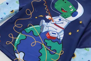 Detail of boys' rash guard featuring space dinosaur print and long raglan sleeves