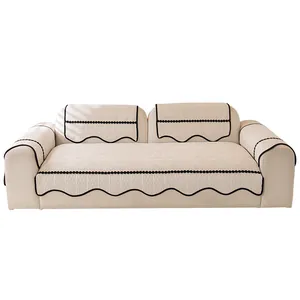 Beige chenille sectional sofa cover set with black wavy edges and textured waffle pattern