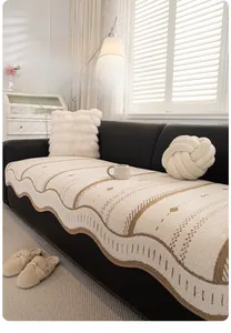 Detail of crochet-edge beige sofa cushion with wave trim and geometric pattern