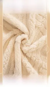 Macro close-up of thick cream white sherpa fleece fabric showing soft plush texture