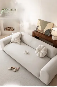 Close-up of soft beige polar fleece sofa cover with thick elastic texture in a cozy living room