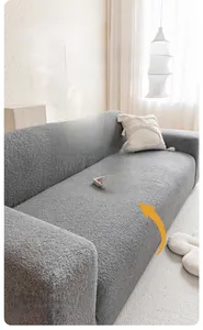 Detail of grey teddy fleece sofa cover showing textured fabric and full-coverage fit
