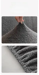 Detail of grey teddy fleece sofa cover showing textured fabric and elastic non-slip band