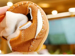 Close-up of flexible baby winter shoe with warm plush lining and soft rubber sole