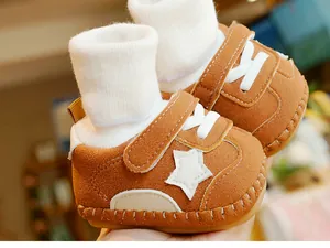 Detail of warm brown baby walker shoe with white star patch and soft anti-slip sole
