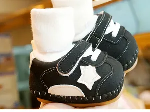 Detail of baby walking shoes with white star pattern and durable brown gum sole