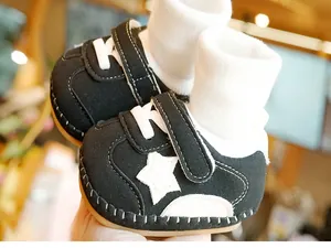 Detailed close-up of baby walker shoe with soft sole, white star, and stitching details