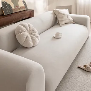 Modern creamy white fleece sofa cover with textured fabric and pumpkin pillow on 3-seater