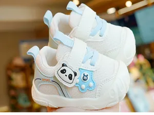 Close-up of baby walking shoes with breathable white mesh and blue panda patches