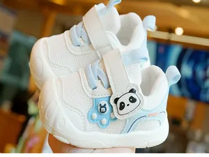 Detail of baby walking shoes with breathable mesh, velcro strap, and cute panda decoration
