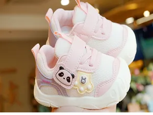 Close-up of pink baby walking shoes with panda motif and secure velcro strap
