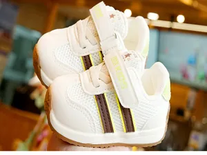 Detail of baby walking shoes with mesh fabric, brown stripes, and rubber soles