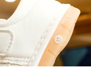 Detail of anti-slip rubber sole and double stitching on white toddler sneakers