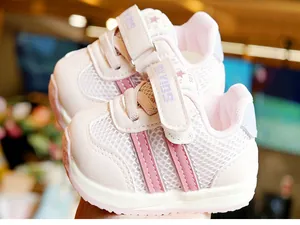 Close-up of pink and white toddler shoes featuring breathable mesh and Velcro strap
