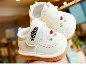 Detail of baby walking shoes featuring floral embroidery and a convenient Velcro strap