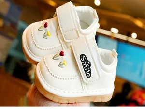 Detail of baby walking shoes with tulip embroidery and non-slip rubber soles